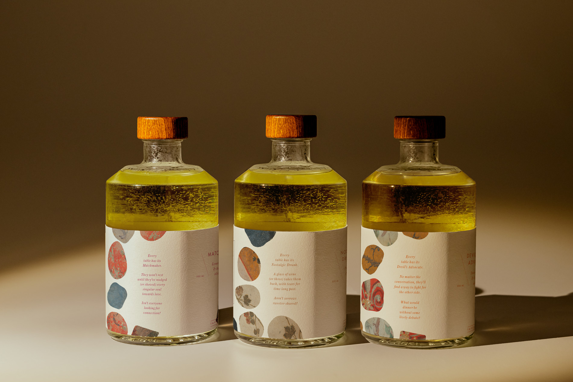 three ceramic olive oil bottles showing the backs of their labels